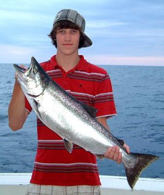 Dillion Tristani with another Kenosha Wisconsin Salmon caught while charter fishing with Albatross Sportfishing Charters.